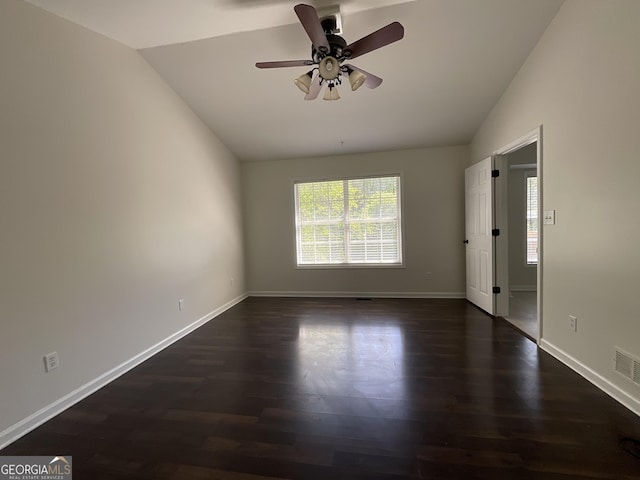 unfurnished room featuring ceiling fan, baseboards, lofted ceiling, and dark wood-type flooring