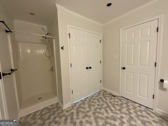 bathroom with crown molding, baseboards, a shower, and visible vents