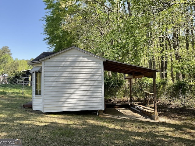 view of outbuilding featuring an outdoor structure and fence