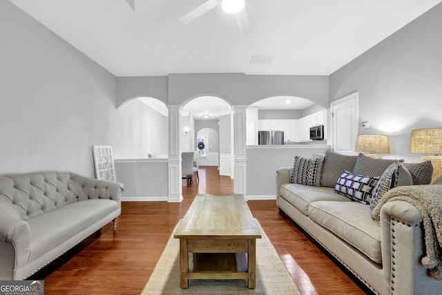 6330 Elmshorn Way, Alpharetta, GA 30004 - living room featuring decorative columns, arched walkways, a ceiling fan, visible vents, and wood finished floors