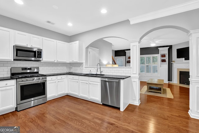 6330 Elmshorn Way, Alpharetta, GA 30004 - kitchen featuring dark countertops, visible vents, ornate columns, stainless steel appliances, and a sink