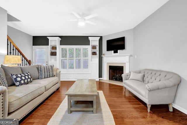 6330 Elmshorn Way, Alpharetta, GA 30004 - living area with stairway, a fireplace with flush hearth, a ceiling fan, and wood finished floors