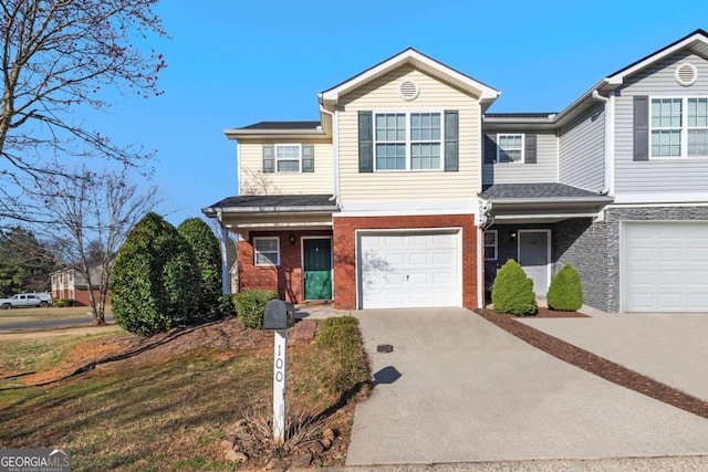 traditional home featuring brick siding, an attached garage, and concrete driveway
