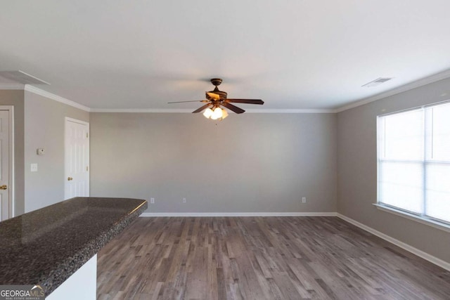 unfurnished living room with ceiling fan, ornamental molding, and visible vents