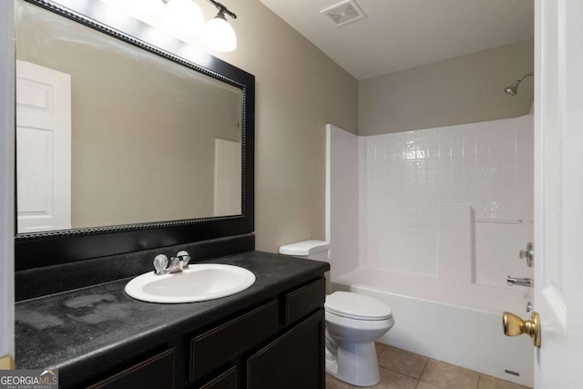 bathroom featuring visible vents, toilet, shower / bathing tub combination, vanity, and tile patterned flooring