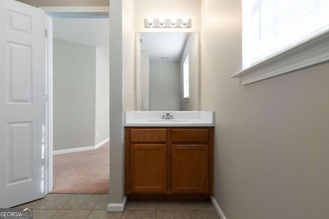 bathroom featuring baseboards, tile patterned flooring, and vanity