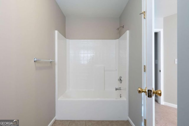 bathroom with shower / tub combination, tile patterned flooring, and baseboards
