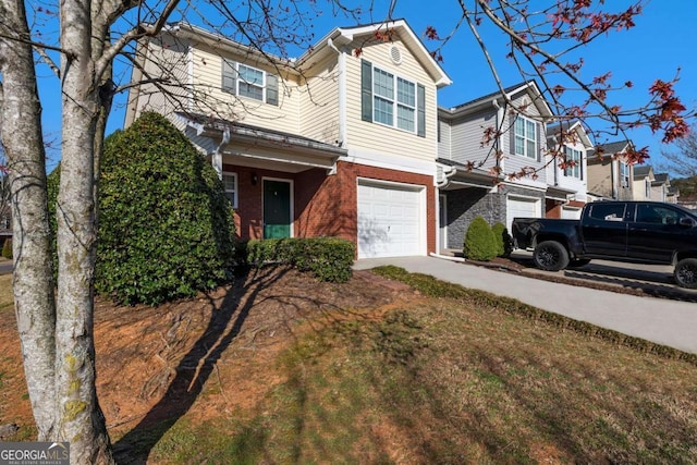 view of front of house featuring brick siding, an attached garage, and concrete driveway