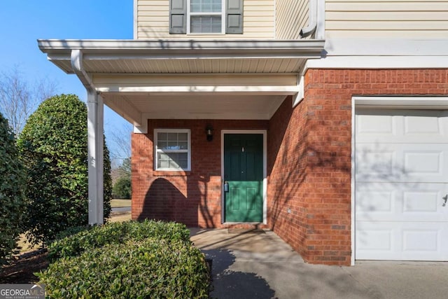 view of exterior entry featuring brick siding