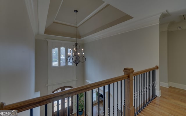 5224 Brendlynn Dr, Suwanee, GA 30024 - interior space with a tray ceiling, ornamental molding, a chandelier, wood finished floors, and baseboards