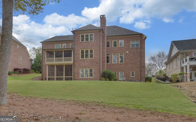 5224 Brendlynn Dr, Suwanee, GA 30024 - rear view of property featuring a yard, brick siding, a sunroom, and a chimney
