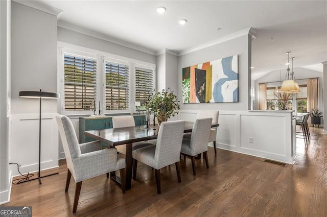 111 Brighton Blvd, Woodstock, GA 30188 - dining space featuring crown molding, a decorative wall, and wood finished floors