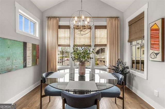 111 Brighton Blvd, Woodstock, GA 30188 - dining space with baseboards, vaulted ceiling, an inviting chandelier, and wood finished floors