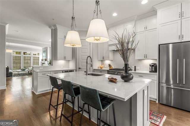 111 Brighton Blvd, Woodstock, GA 30188 - kitchen with dark wood-style floors, a sink, high quality fridge, and hanging light fixtures