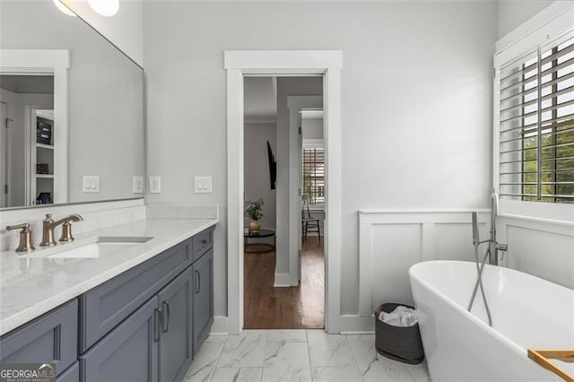111 Brighton Blvd, Woodstock, GA 30188 - full bath featuring vanity, marble finish floor, a wainscoted wall, and a soaking tub