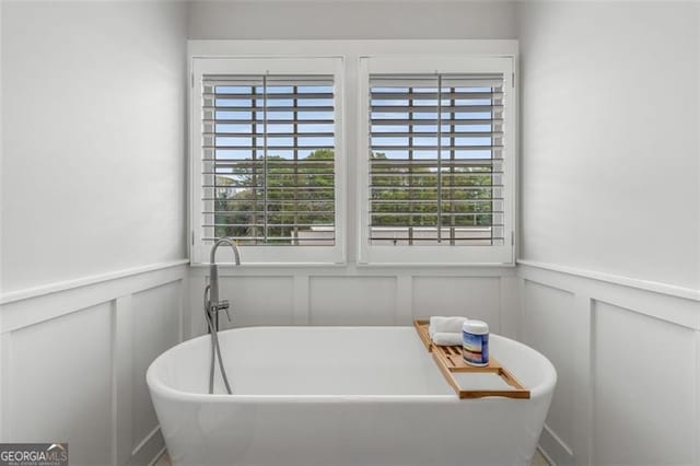 111 Brighton Blvd, Woodstock, GA 30188 - bathroom featuring a soaking tub and a wainscoted wall