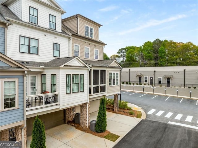 111 Brighton Blvd, Woodstock, GA 30188 - exterior space with central AC, a shingled roof, and uncovered parking