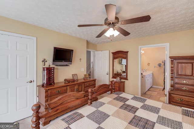 bedroom featuring ceiling fan and connected bathroom