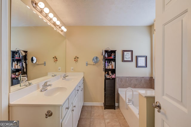 bathroom with a bath, double vanity, a sink, and tile patterned floors