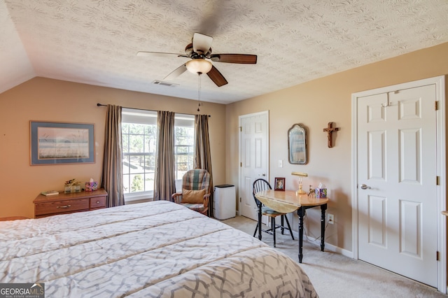 bedroom featuring lofted ceiling, a textured ceiling, light colored carpet, visible vents, and baseboards