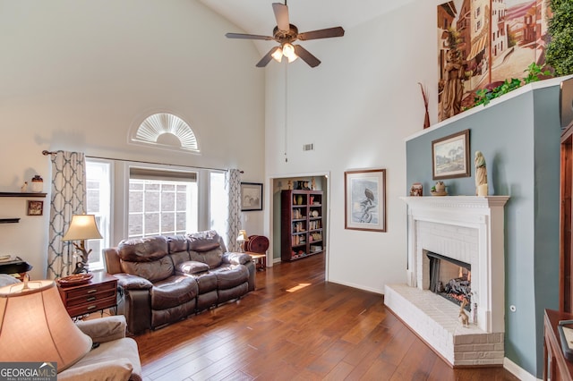 350 Lakeview Bend Cir, Jefferson, GA 30549 - living area featuring high vaulted ceiling, a brick fireplace, a ceiling fan, and wood-type flooring