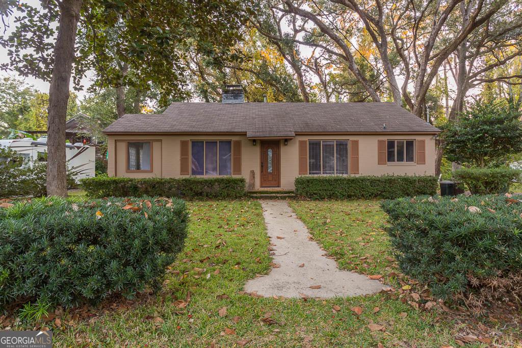 116 Redfern Dr, Saint Simons, GA 31522 - single story home with a front yard and a chimney
