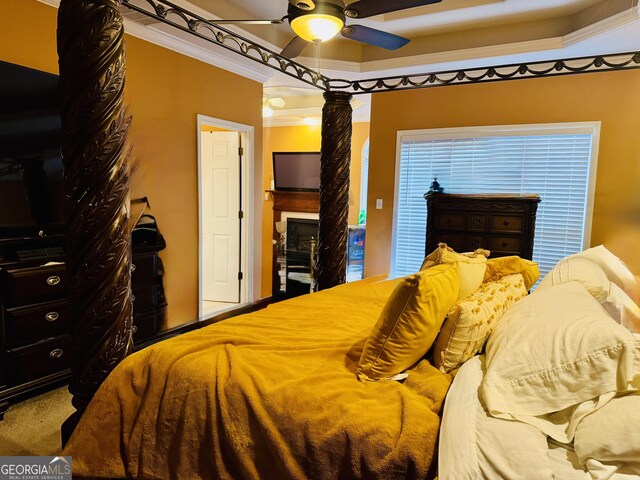 bedroom with crown molding, ornate columns, and a ceiling fan