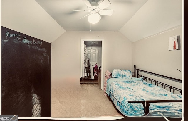 carpeted bedroom featuring a ceiling fan and lofted ceiling
