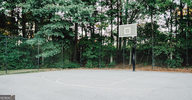 view of basketball court with community basketball court and fence