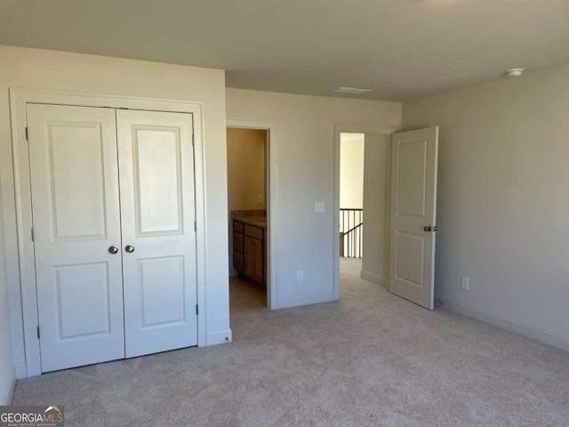 unfurnished bedroom with a closet, baseboards, and carpet floors