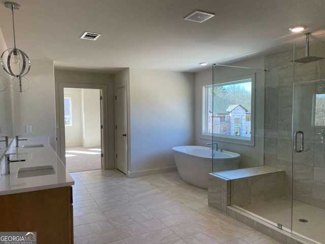 bathroom with a sink, visible vents, a shower stall, and a soaking tub