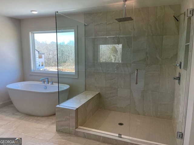 full bath with a shower stall and a soaking tub