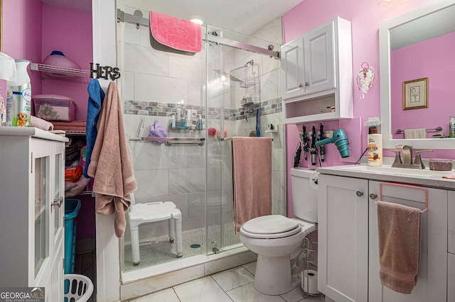 bathroom with toilet, a stall shower, vanity, and marble look tiles