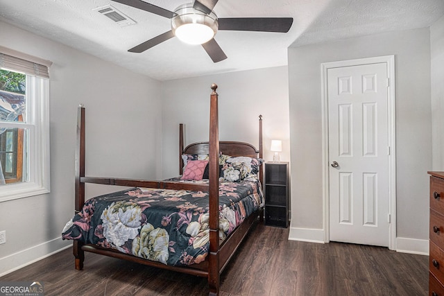 bedroom featuring wood finished floors, baseboards, and a ceiling fan