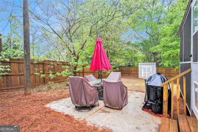 fenced backyard featuring a storage unit, an outbuilding, a patio, and outdoor dining space