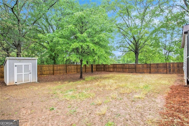 fenced backyard featuring a storage unit and an outdoor structure