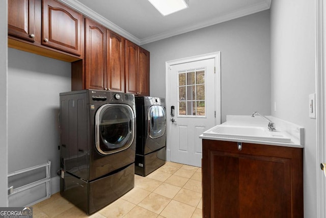 laundry room with crown molding, cabinet space, light tile patterned flooring, a sink, and washing machine and dryer