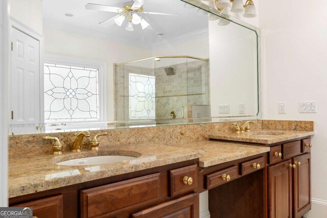 full bathroom featuring a sink, double vanity, a stall shower, and crown molding