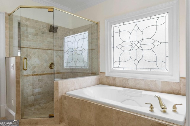 bathroom featuring a shower stall, a bath, and ornamental molding