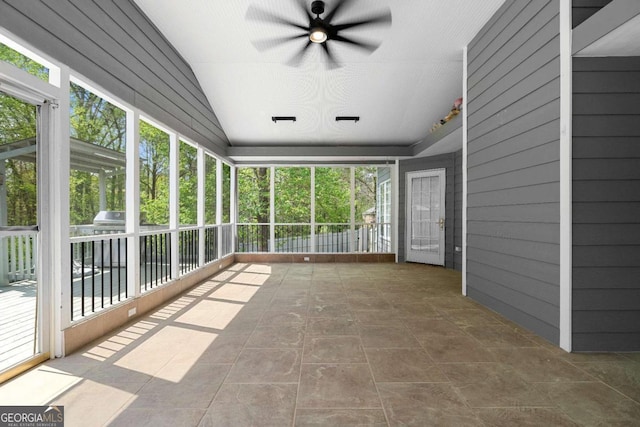 unfurnished sunroom with ceiling fan and a wealth of natural light