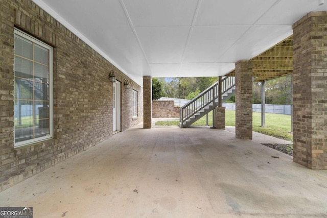 view of patio / terrace with fence and stairs