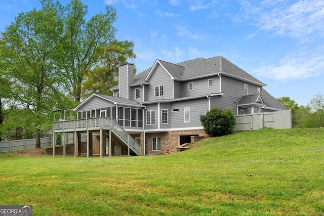 back of house with a sunroom, a yard, a chimney, fence, and stairs