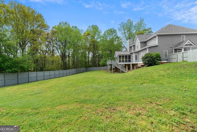 view of yard featuring stairway, a fenced backyard, and a deck