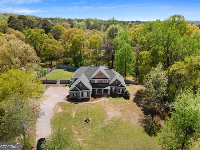 drone / aerial view with a wooded view