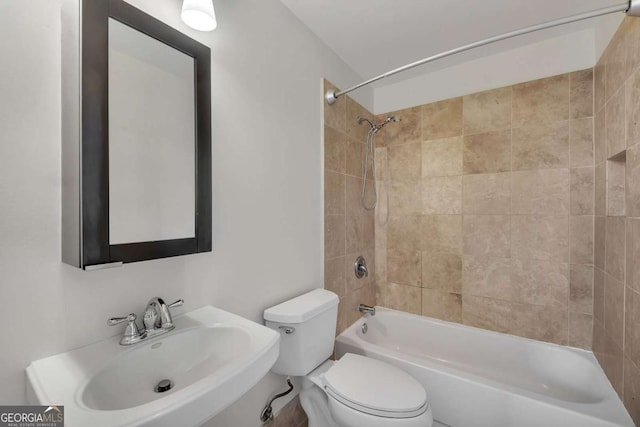 bathroom featuring a sink, toilet, and  shower combination