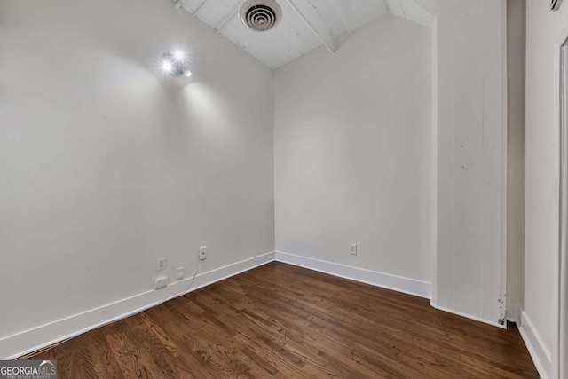 unfurnished room with dark wood-type flooring, baseboards, and visible vents