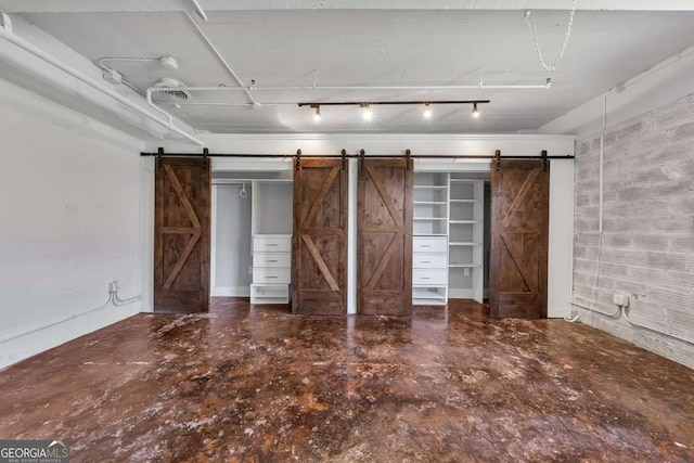 unfurnished bedroom featuring a barn door