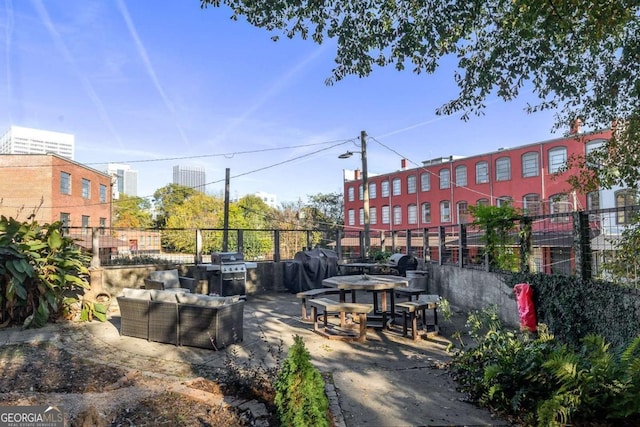 view of community with a patio area and fence