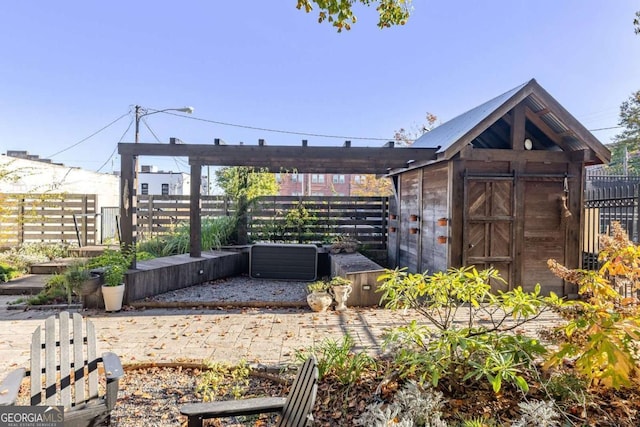 exterior space with a storage shed, fence, and an outdoor structure