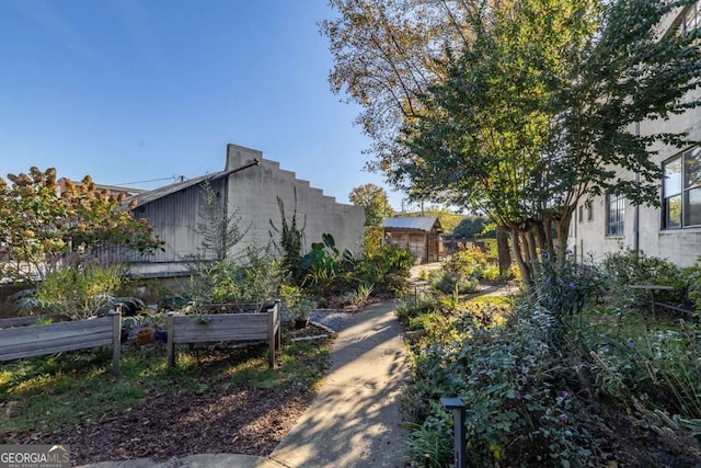view of property exterior featuring a garden